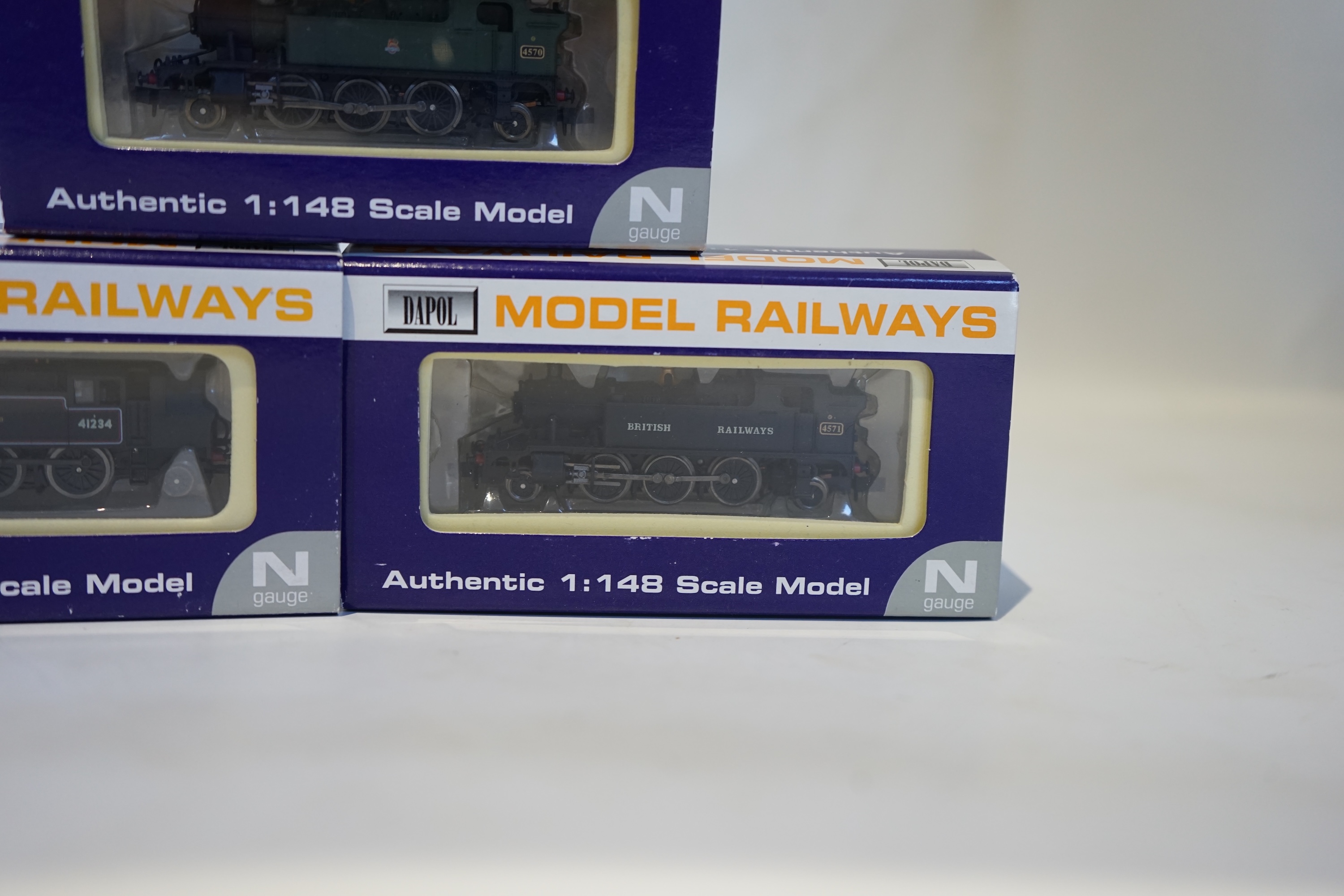 Three boxed Dapol N gauge railway BR tank locomotives; an Ivatt 2-6-2T, 41234 (ND-061A), a Class 45xx, 4571 (ND-024), and a Class 45xx, 4570 (ND-013). Condition - good.